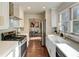 Modern kitchen with white cabinets, stainless steel appliances and quartz countertops at 1080 Willow Bnd, Roswell, GA 30075