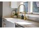 Kitchen features a farmhouse sink and modern gold faucet at 1080 Willow Bnd, Roswell, GA 30075