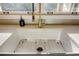 White kitchen sink with gold faucet and stainless steel grid at 1080 Willow Bnd, Roswell, GA 30075