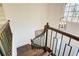 Dark wood staircase with metal railing and arched window above at 1080 Willow Bnd, Roswell, GA 30075