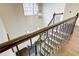 Dark wood staircase with metal railing and arched window above at 1080 Willow Bnd, Roswell, GA 30075