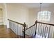 Dark wood staircase with metal railing and arched window above at 1080 Willow Bnd, Roswell, GA 30075