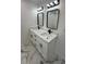 Modern bathroom with double vanity, white cabinets, marble countertop, and black hardware at 205 Hardman Way, Woodstock, GA 30188