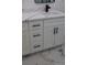 Modern bathroom vanity with white cabinets, quartz countertop, and black hardware at 205 Hardman Way, Woodstock, GA 30188