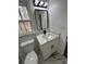 Bathroom featuring a stylish vanity with marble countertop and modern lighting fixtures at 205 Hardman Way, Woodstock, GA 30188