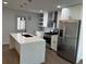 Modern kitchen featuring stainless steel appliances, white cabinets, quartz countertops, and island at 205 Hardman Way, Woodstock, GA 30188