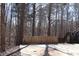 Concrete patio area in wooded setting with wooden fence at 205 Hardman Way, Woodstock, GA 30188