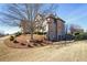 Brick home featuring a landscaped yard, a gated entrance, and a tiered retaining wall at 2602 Alcovy Club Dr, Dacula, GA 30019