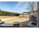 Spacious backyard featuring manicured lawn, brick retaining wall, and wrought iron fence at 2602 Alcovy Club Dr, Dacula, GA 30019