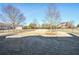 Large backyard featuring a spacious lawn area bordered by a black fence, with other houses visible at 2602 Alcovy Club Dr, Dacula, GA 30019
