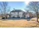 Expansive backyard view with a spacious lawn, mature trees and the back exterior of the home at 2602 Alcovy Club Dr, Dacula, GA 30019