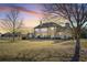 Spacious backyard with a multi-story home and a beautiful sunset at 2602 Alcovy Club Dr, Dacula, GA 30019