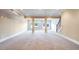 Large, finished basement space featuring neutral carpet, support columns, and access to the backyard at 2602 Alcovy Club Dr, Dacula, GA 30019