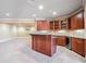 Basement featuring carpeted floors and a bar with wood cabinets, granite countertops, and a wine rack at 2602 Alcovy Club Dr, Dacula, GA 30019