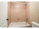 Bathroom with a bathtub, ceramic tile shower, a toilet, and a shower head at 2602 Alcovy Club Dr, Dacula, GA 30019