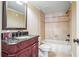 Bathroom featuring a vanity with a granite countertop, framed mirror, and a tiled shower/tub combination at 2602 Alcovy Club Dr, Dacula, GA 30019