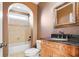 Bathroom with decorative cabinet, a black granite countertop and framed mirror at 2602 Alcovy Club Dr, Dacula, GA 30019