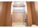 Bathtub in a bathroom featuring warm-toned walls and tiles, plus a shower fixture at 2602 Alcovy Club Dr, Dacula, GA 30019