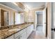 Bathroom featuring double sinks, granite countertops, updated fixtures and a framed mirror at 2602 Alcovy Club Dr, Dacula, GA 30019