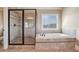 Bathroom featuring a separate glass shower, a garden tub, and tile accents at 2602 Alcovy Club Dr, Dacula, GA 30019
