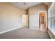 Neutral bedroom with vaulted ceilings, large windows, and plush carpeting at 2602 Alcovy Club Dr, Dacula, GA 30019