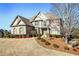 Brick home with shuttered windows, landscaping, and a mature tree in the front yard at 2602 Alcovy Club Dr, Dacula, GA 30019