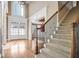 Bright foyer features hardwood floors, a staircase, and a grand entrance with French doors at 2602 Alcovy Club Dr, Dacula, GA 30019