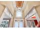 Elegant foyer showcases high ceilings, a decorative light fixture, and an arched transom window at 2602 Alcovy Club Dr, Dacula, GA 30019