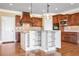 Kitchen island with granite countertops and storage, stainless appliances, and custom wood cabinets at 2602 Alcovy Club Dr, Dacula, GA 30019