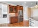 Kitchen area with wood cabinets, stainless steel fridge, and granite countertops, adjacent to dining and living areas at 2602 Alcovy Club Dr, Dacula, GA 30019