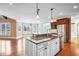 Kitchen with granite countertops, stainless appliances, and a kitchen island that opens into an eat-in area at 2602 Alcovy Club Dr, Dacula, GA 30019