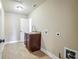 Laundry room with neutral colored walls, a utility sink, and ceramic tile floors at 2602 Alcovy Club Dr, Dacula, GA 30019