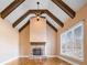 Living room featuring high ceilings with wooden beams, stone fireplace, and large windows at 2602 Alcovy Club Dr, Dacula, GA 30019