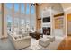 Spacious living room features tall windows, fireplace, and built-in bookshelves at 2602 Alcovy Club Dr, Dacula, GA 30019