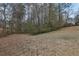 Sloped backyard with mature trees and shrubs at 2925 Fern Valley Sw Dr, Marietta, GA 30008