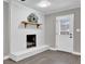 White brick fireplace with wood mantel and hearth at 2925 Fern Valley Sw Dr, Marietta, GA 30008