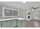 Kitchen with light green cabinets, white counters and view to living room at 2925 Fern Valley Sw Dr, Marietta, GA 30008