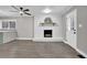 Living room with fireplace, wood-look floors, and ceiling fan at 2925 Fern Valley Sw Dr, Marietta, GA 30008