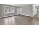 Spacious living room with gray walls, wood-look floors, and large windows at 2925 Fern Valley Sw Dr, Marietta, GA 30008