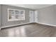 Spacious living room with gray walls, wood-look floors, and large windows at 2925 Fern Valley Sw Dr, Marietta, GA 30008