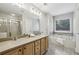 Well-lit bathroom with double sinks, a soaking tub, and a separate glass-enclosed shower at 3901 Old Atlanta Station Se Dr, Atlanta, GA 30339