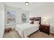 Bright bedroom with a dark wood bed frame, plush carpet, natural light, and coordinating dark wood night stand at 3901 Old Atlanta Station Se Dr, Atlanta, GA 30339