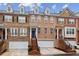 Charming townhome exterior featuring brick facade, private entrances, and attached garages for convenient parking at 3901 Old Atlanta Station Se Dr, Atlanta, GA 30339