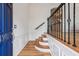 Foyer with hardwood floors, staircase with metal banister, and paneled walls at 3901 Old Atlanta Station Se Dr, Atlanta, GA 30339