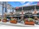 Patio view of Todd English Tavern with umbrellas, planters and diners at 3901 Old Atlanta Station Se Dr, Atlanta, GA 30339