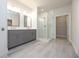 Bathroom featuring double vanity with gray cabinets, a glass-enclosed shower, and modern fixtures at 504 Winston Croft Cir # 54, Johns Creek, GA 30022