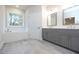 Bathroom featuring double vanity with gray cabinets, a soaking tub, and modern fixtures at 504 Winston Croft Cir # 54, Johns Creek, GA 30022