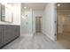 Bathroom featuring a gray vanity, glass-enclosed shower with white tile, and modern fixtures at 504 Winston Croft Cir # 54, Johns Creek, GA 30022