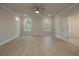 Well-lit bedroom with hardwood floors, neutral paint, modern ceiling fan, and two windows at 504 Winston Croft Cir # 54, Johns Creek, GA 30022