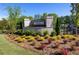 Beautiful community entrance sign surrounded by landscaping with colorful flowers at 504 Winston Croft Cir # 54, Johns Creek, GA 30022